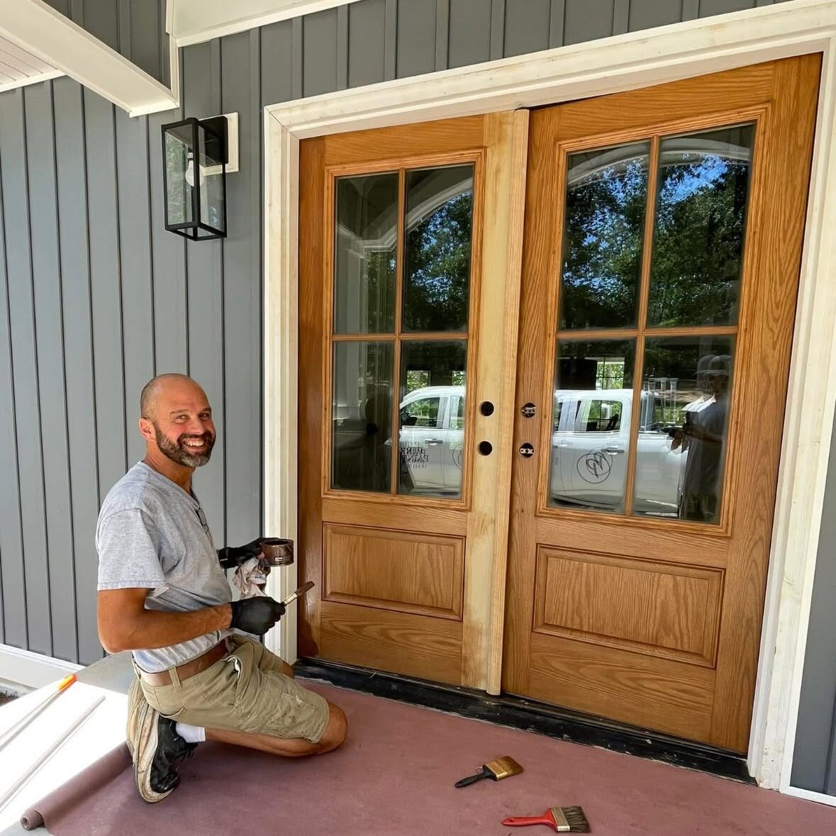 Logan Perry staining a custom door